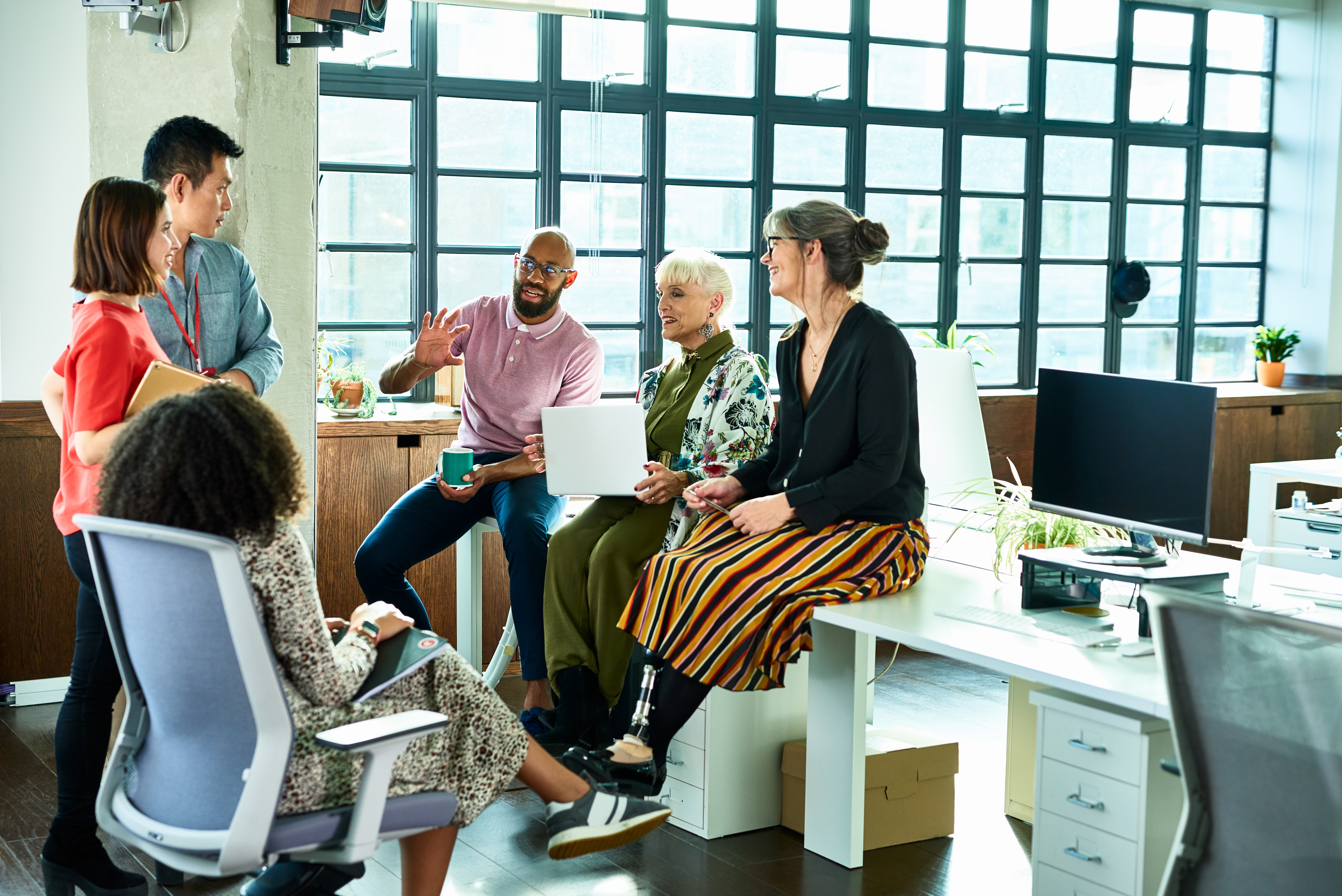 Eye-level view of a diverse team collaborating in a bright office space