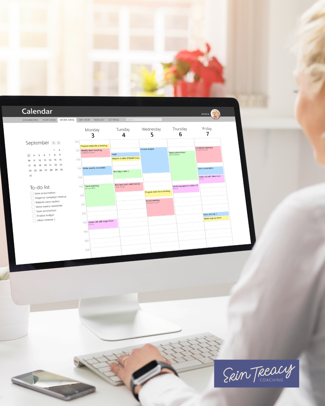 Woman looking at a busy calendar on her desktop computer.